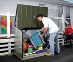 The Stowaway garden storage unit has an olive green roofand door, and 